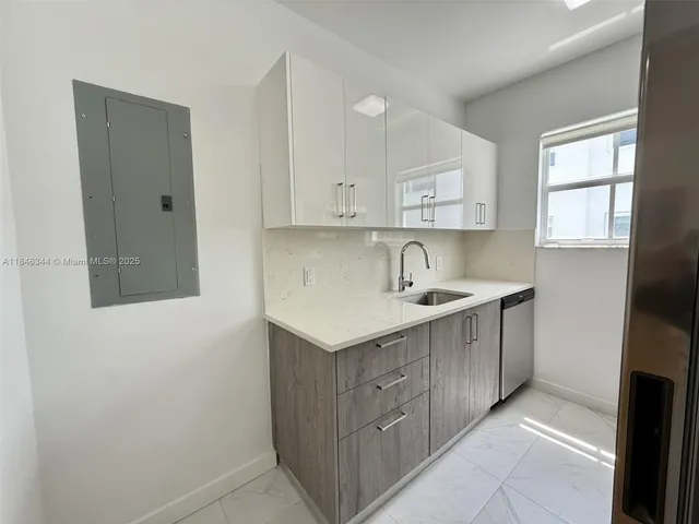 a kitchen with a sink cabinets and window