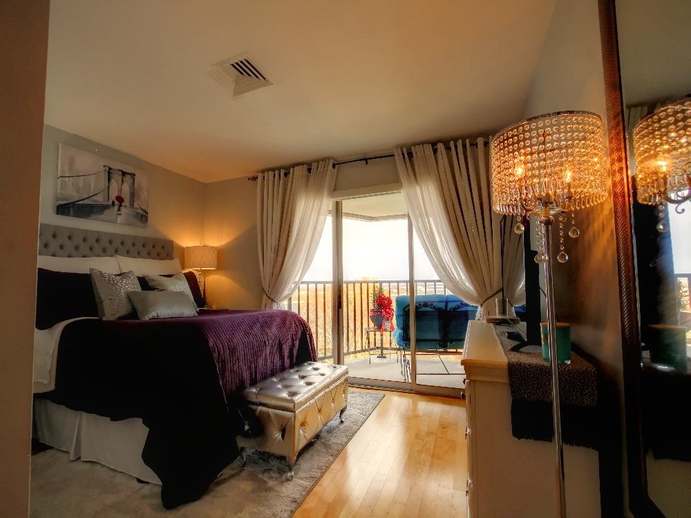 655 Riverside Drive, Unit 805A Memphis, TN 38103 - Photo 11 of 25 a living room with furniture and a floor to ceiling window