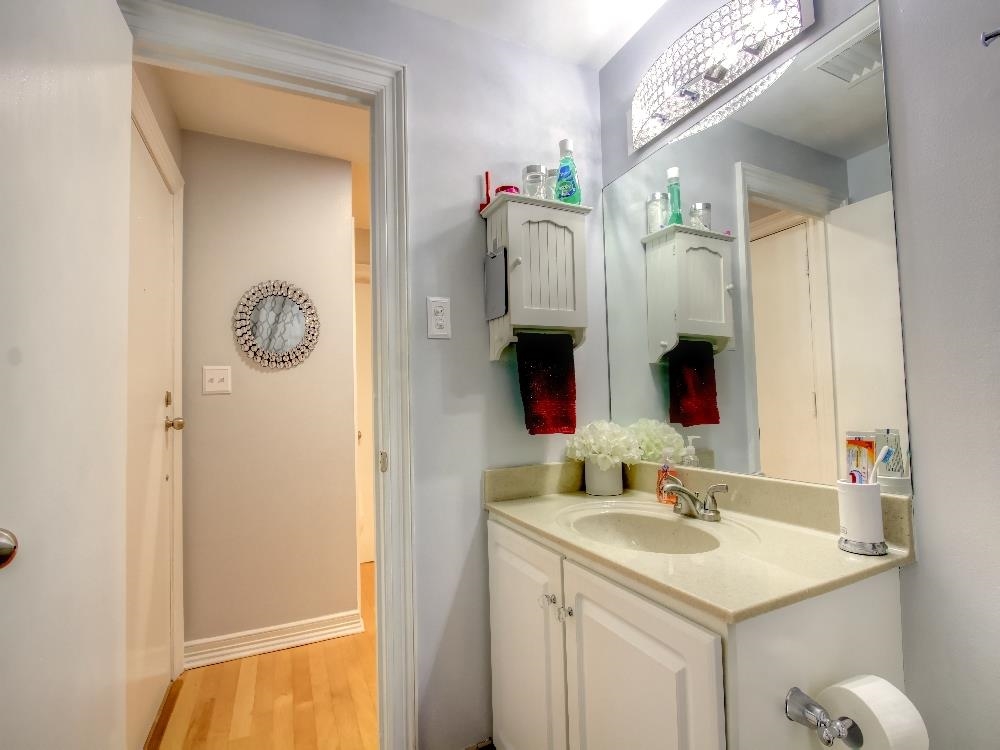 655 Riverside Drive, Unit 805A Memphis, TN 38103 - Photo 14 of 25 a bathroom with a sink vanity and mirror