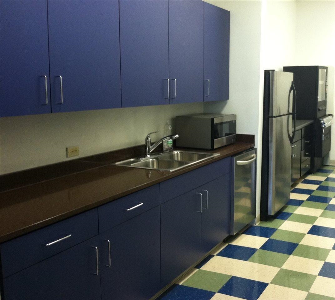 655 Riverside Drive, Unit 805A Memphis, TN 38103 - Photo 22 of 25 a kitchen with a sink a refrigerator and cabinets