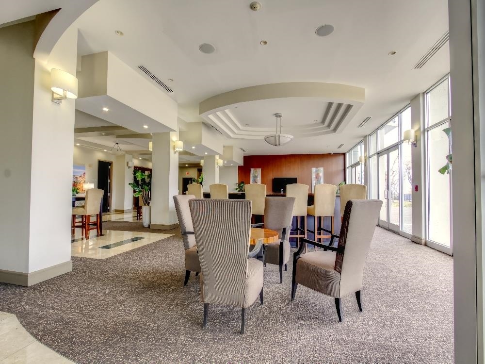 655 Riverside Drive, Unit 805A Memphis, TN 38103 - Photo 24 of 25 a dining room with furniture and a floor to ceiling window