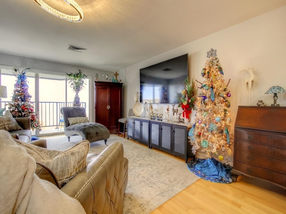 655 Riverside Drive, Unit 805A Memphis, TN 38103 - Photo 5 of 25 a living room with furniture and a chandelier