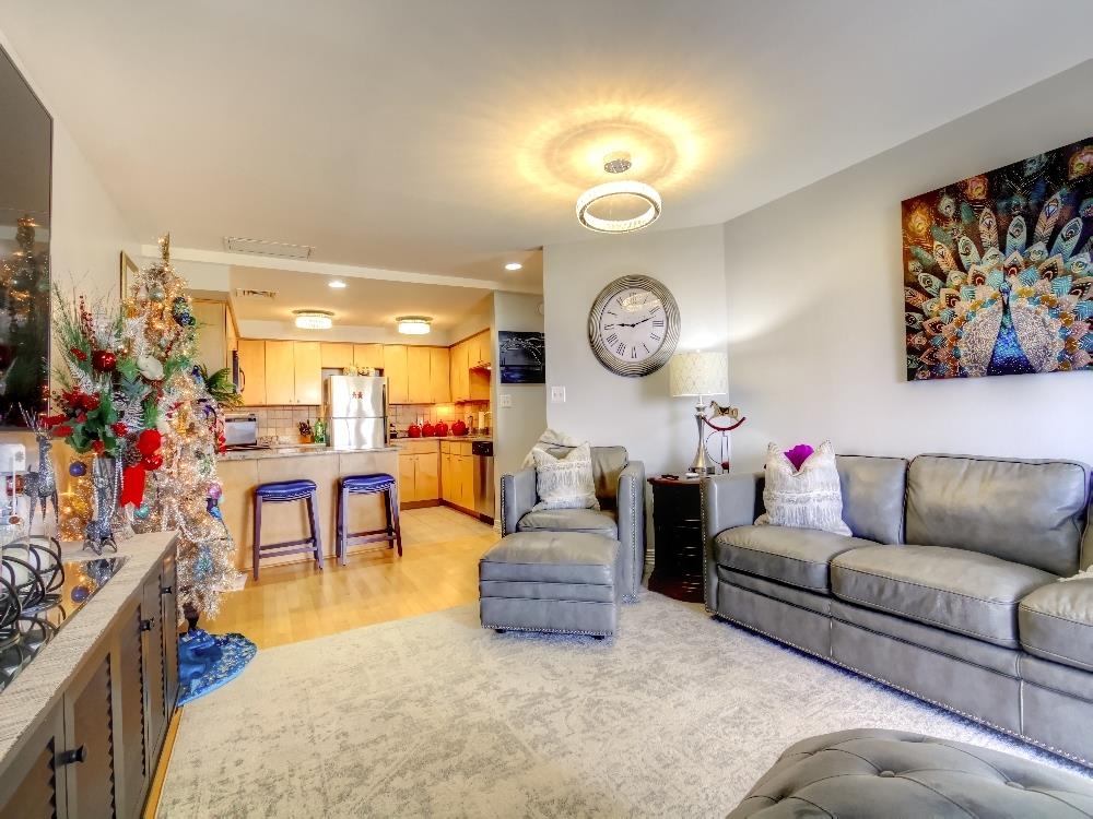 655 Riverside Drive, Unit 805A Memphis, TN 38103 - Photo 6 of 25 a living room with furniture and a clock