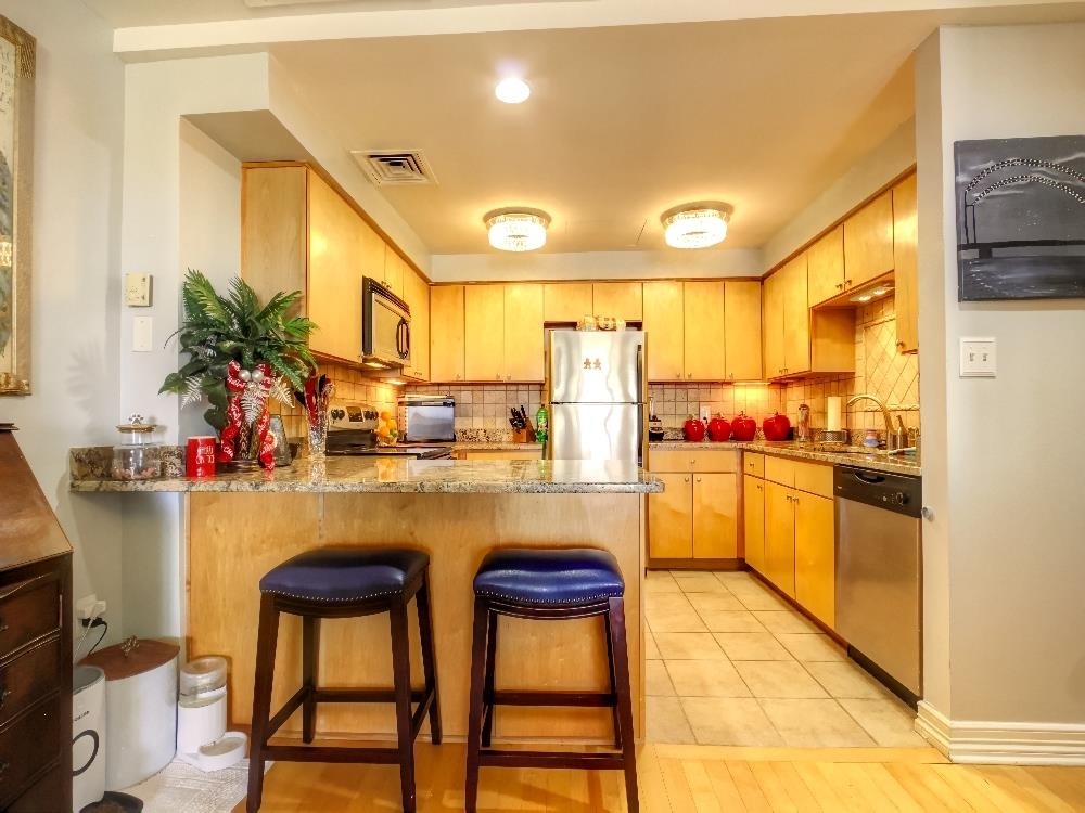 655 Riverside Drive, Unit 805A Memphis, TN 38103 - Photo 7 of 25 a kitchen with refrigerator and cabinets