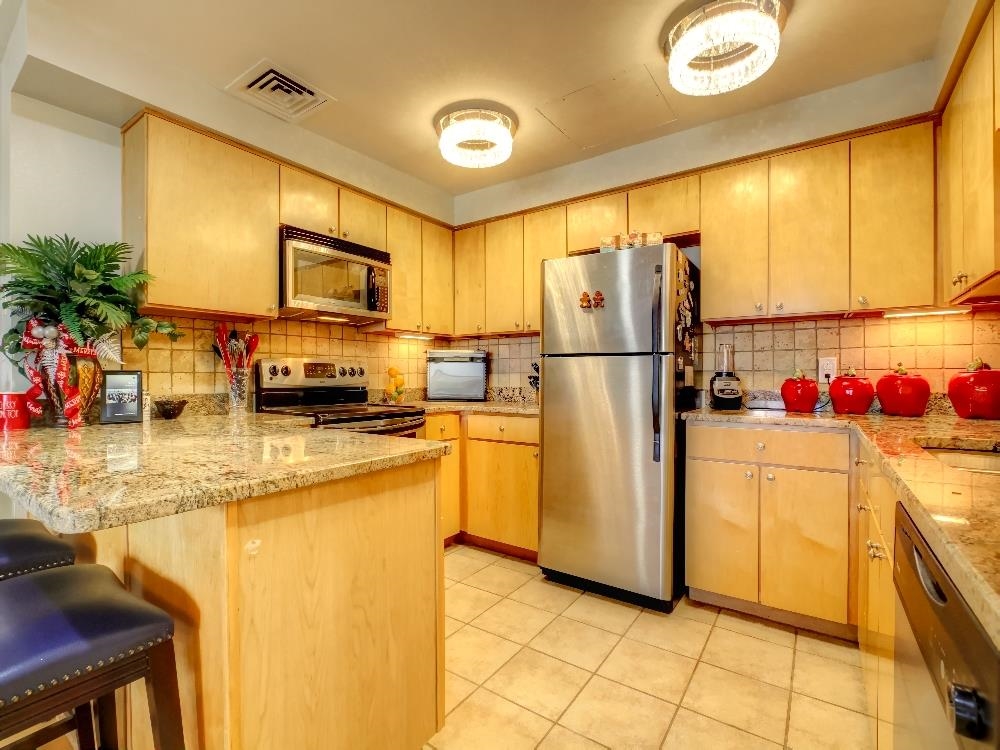 655 Riverside Drive, Unit 805A Memphis, TN 38103 - Photo 8 of 25 a kitchen with refrigerator and cabinets