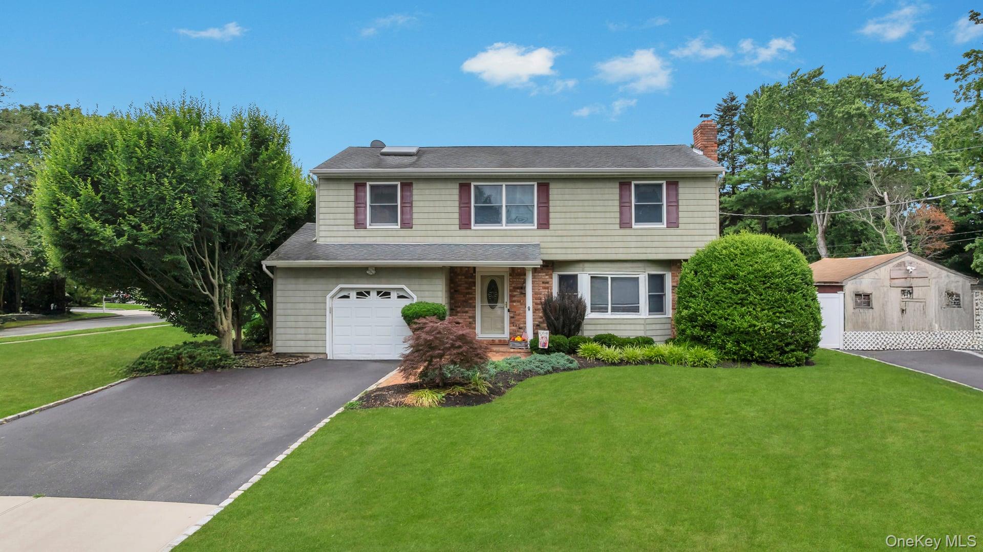 120 Mills Pond Road St. James, NY 11780 - Photo 1 of 1 a front view of a house with a yard and porch