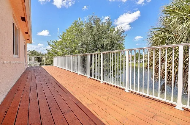 a view of balcony with wooden floor