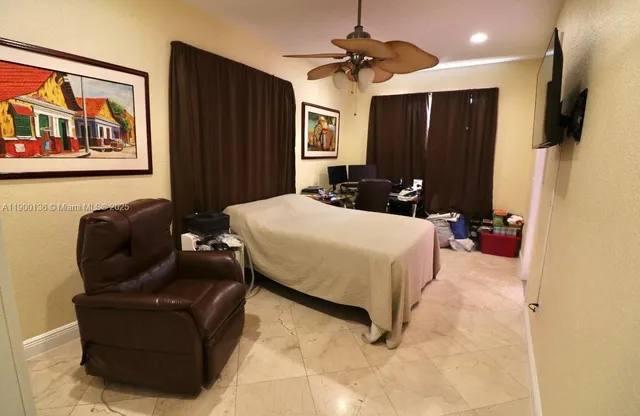 a bed room with a bed window and a television