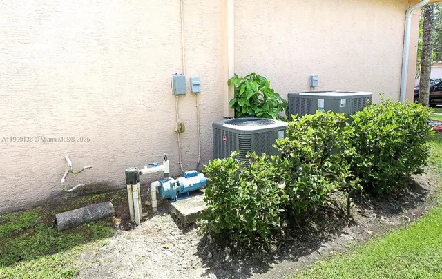 a front view of a house with lots of trees