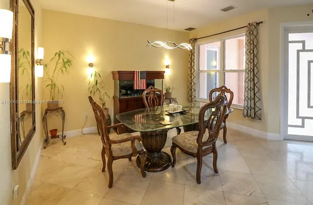 a view of a dining room with furniture and a window