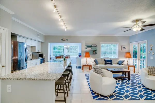 a living room with fireplace furniture and a large window