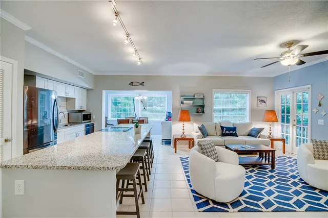 a living room with fireplace furniture and a large window