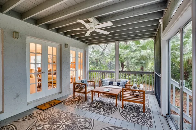 a living room with furniture and a floor to ceiling window