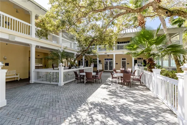 a view of a house with a patio and wooden fence
