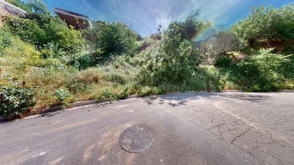 a view of a street with a yard