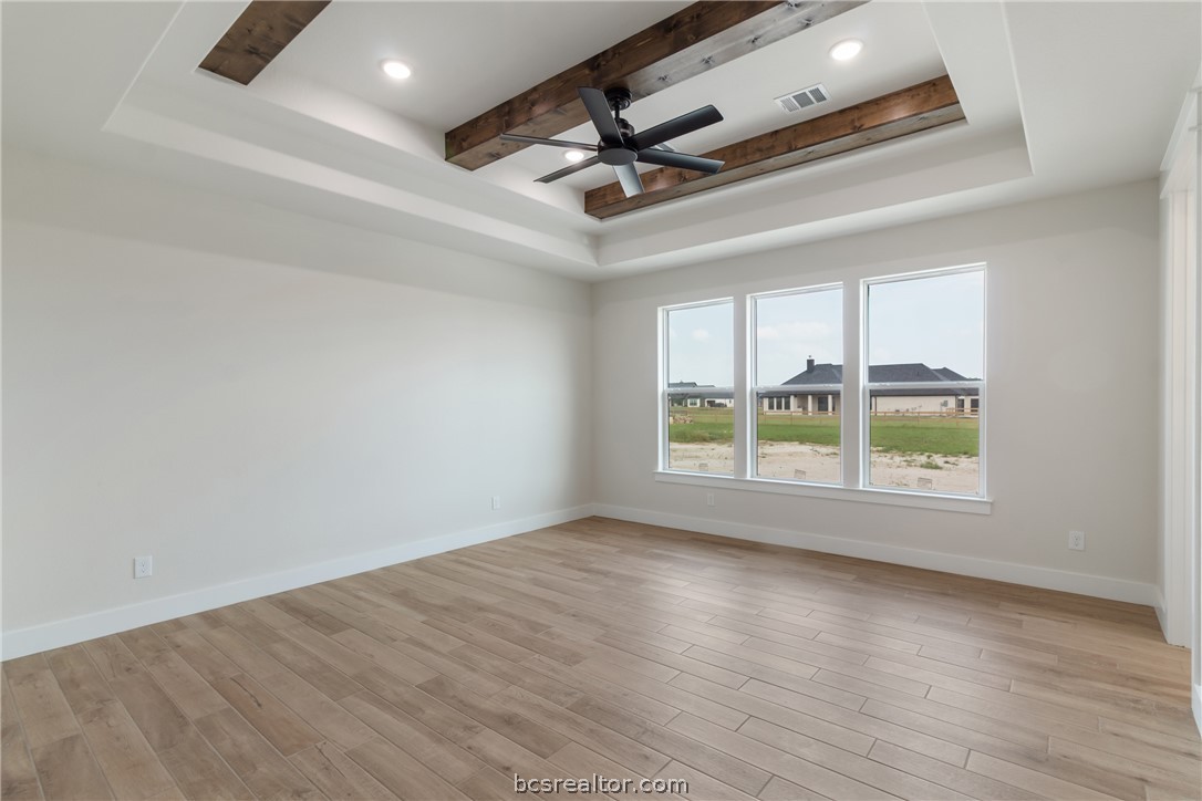 7822 Mathis Crk Drive Bryan, TX 77808 - Photo 17 of 43 an empty room with wooden floor and windows
