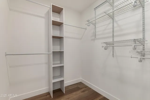 a view of walk in closet with empty racks