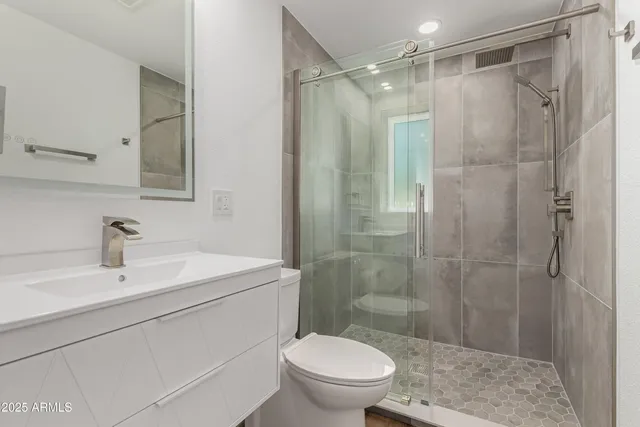 a bathroom with a sink toilet and shower
