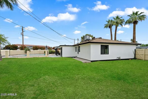 a view of a house with a backyard