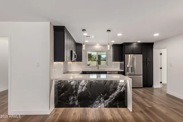 a view of kitchen with refrigerator microwave and wooden floor