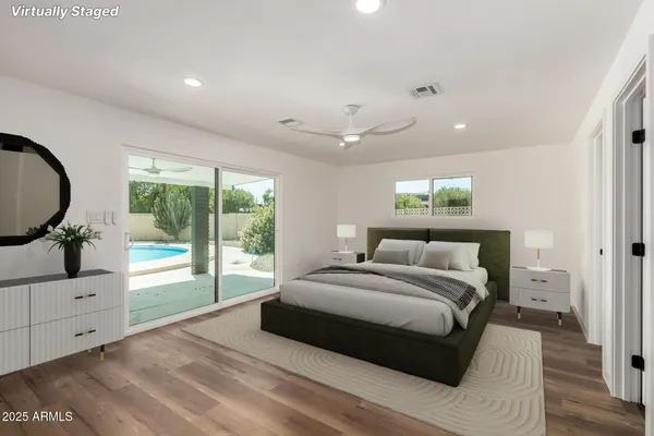 a bedroom with a large bed and a large window