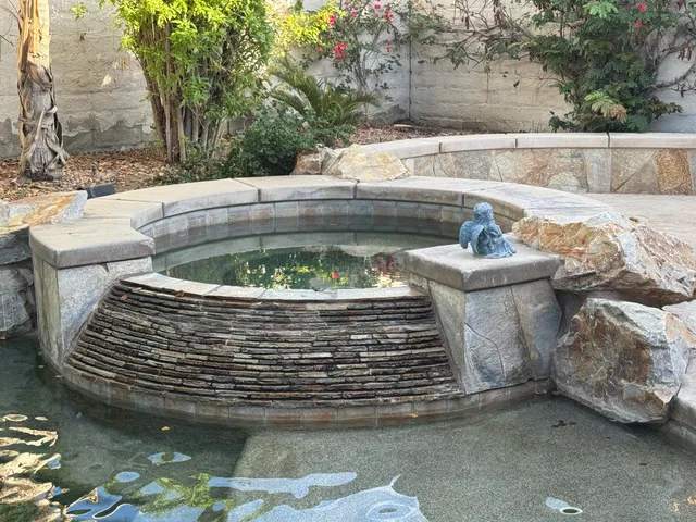 a view of swimming pool with outdoor seating and plants