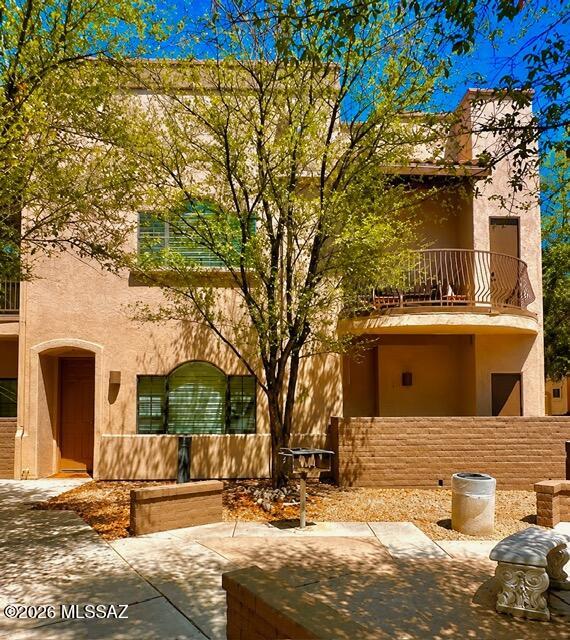 2018 East River Road, Unit 102 Tucson, AZ 85718 - Photo 3 of 25 a front view of a house with a yard