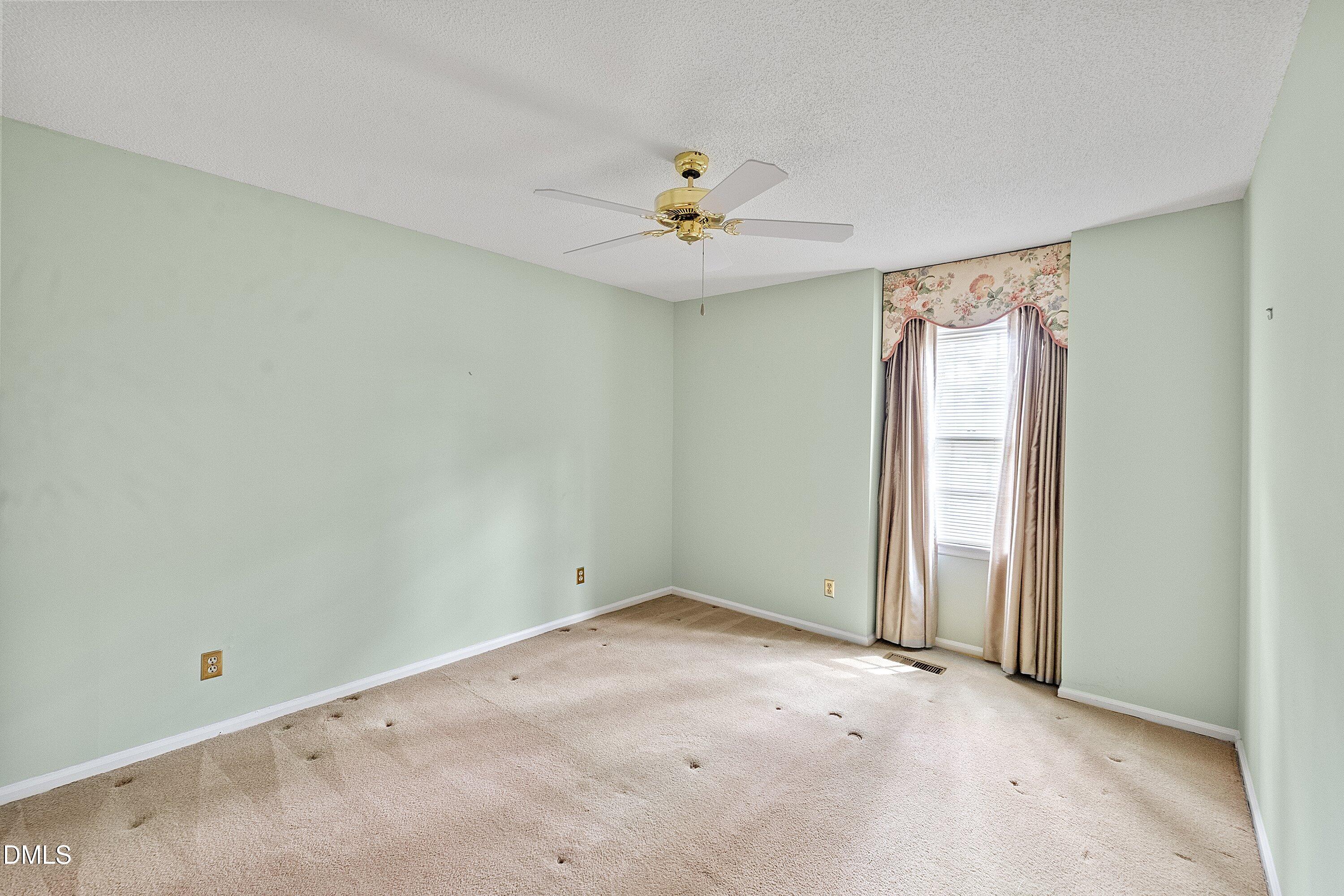 1429 Falls Church Road Raleigh, NC 27609 - Photo 38 of 60 an empty room with windows and fan