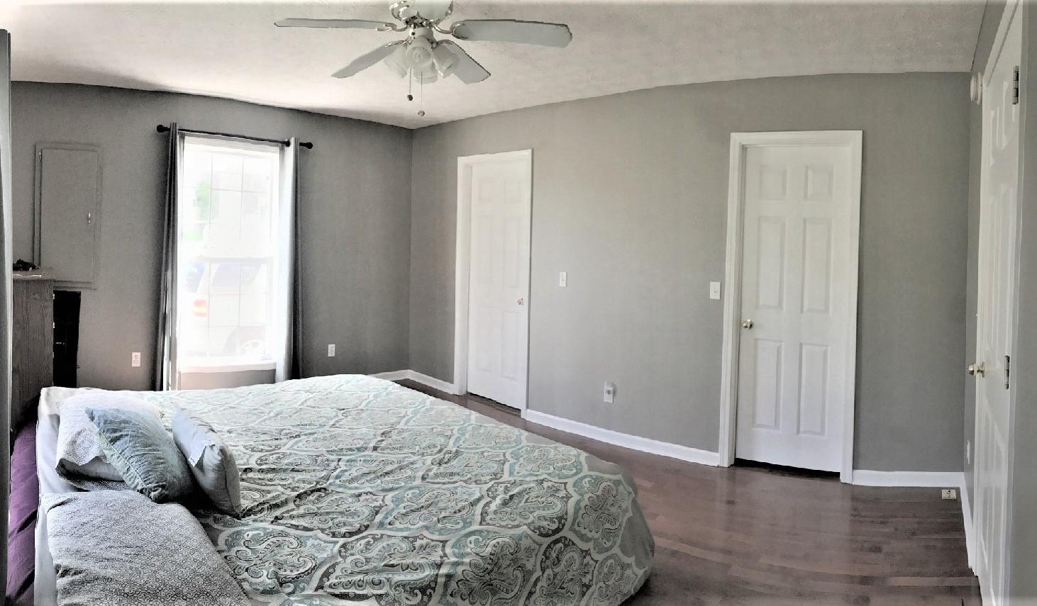 1525 Rapids Road Portland, TN 37148 - Photo 11 of 14 a bedroom with a bed and a chandelier
