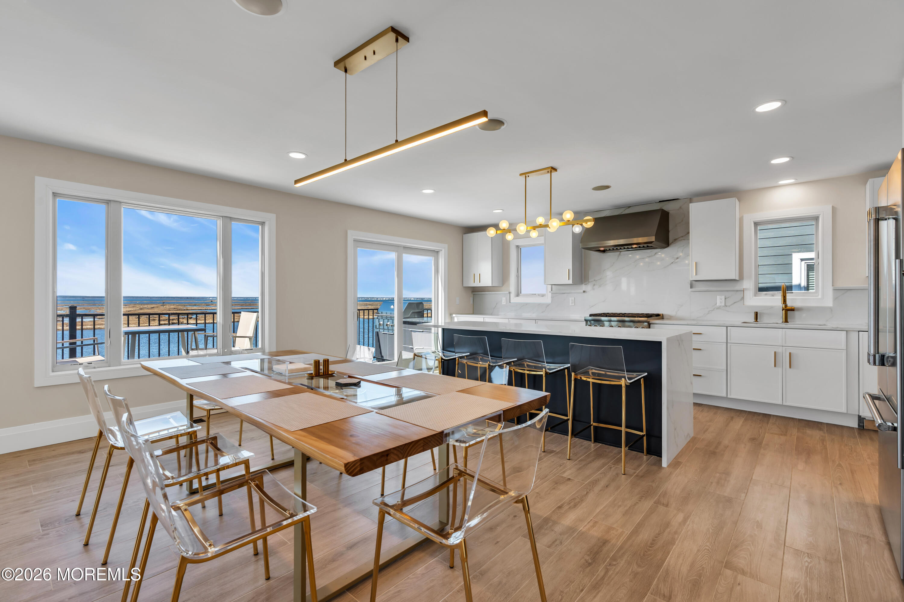 459 Boca Raton Drive Lavallette, NJ 08735 - Photo 21 of 73 a open kitchen with stainless steel appliances granite countertop a stove a refrigerator a kitchen island a table and chairs in it