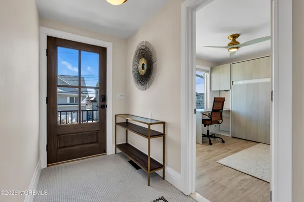 a open kitchen with stainless steel appliances granite countertop a stove a refrigerator a kitchen island a table and chairs in it
