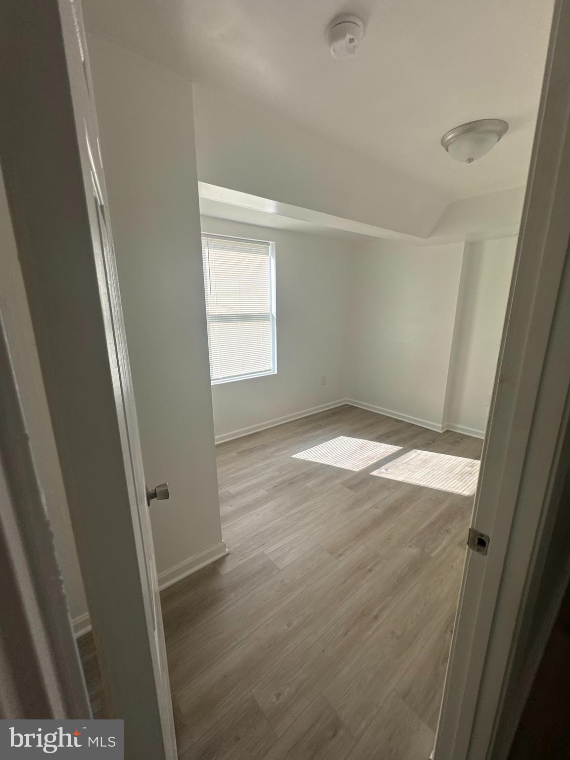 3930 1st Street Southeast, Unit 301 Washington, DC 20032 - Photo 3 of 9 an empty room with wooden floor and windows
