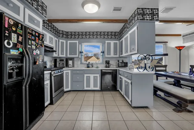a kitchen with a sink appliances and cabinets