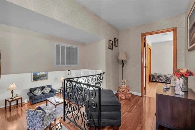 a bedroom with bed and wooden floor