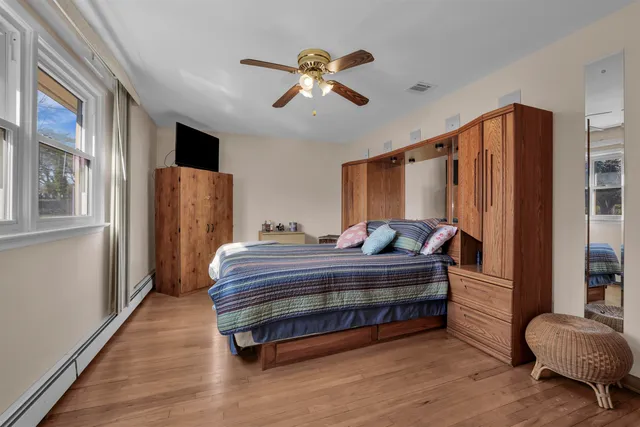 a view of bedroom with furniture and wooden floor