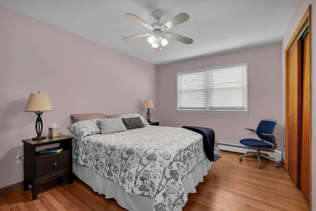 a bedroom with a bed window and a dresser