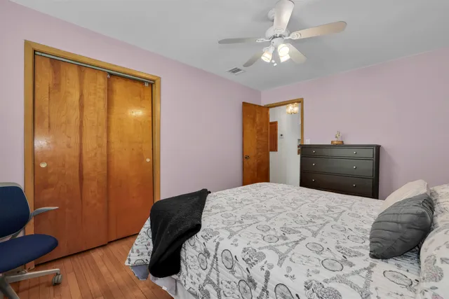 a bedroom with a bed window and a desk