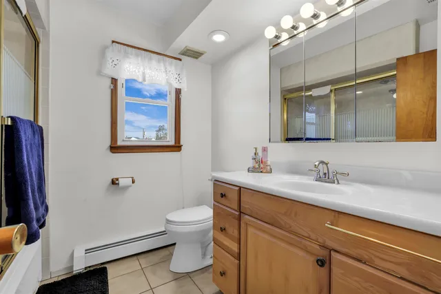 a living room with furniture a wooden floor and a flat screen tv