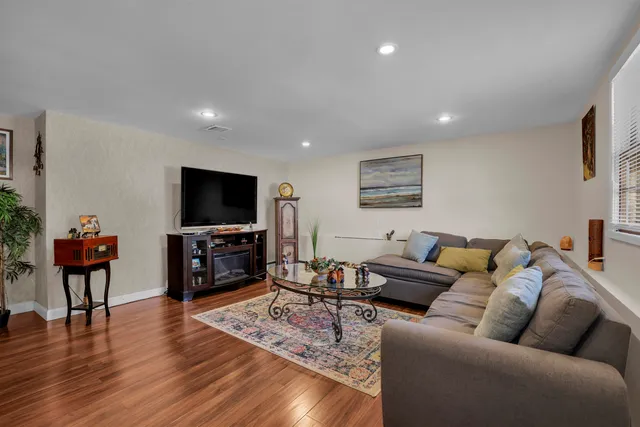 a living room with furniture and wooden floor