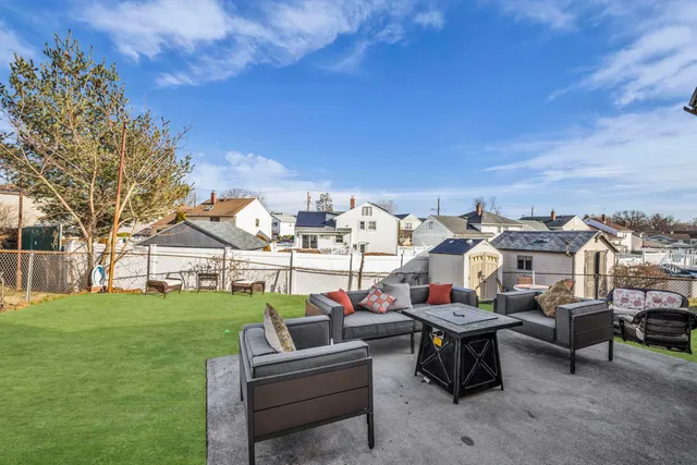 a view of a house with backyard porch and sitting area