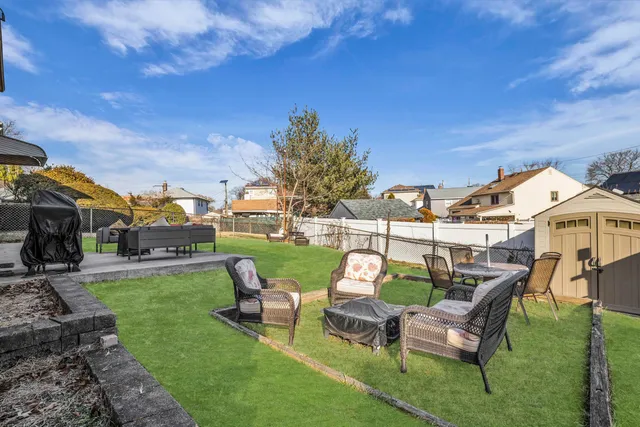 a backyard of a house with table and chairs