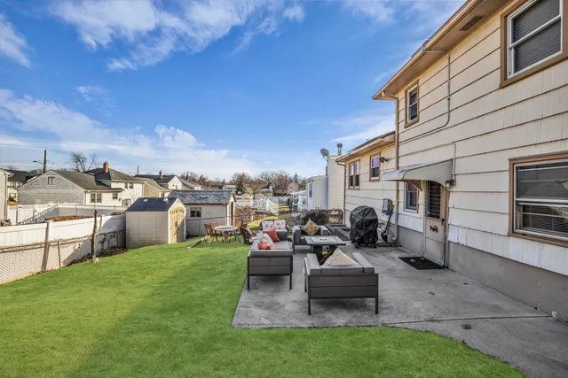 a backyard of a house with table and chairs