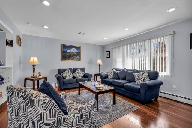 a living room with furniture a rug and a window