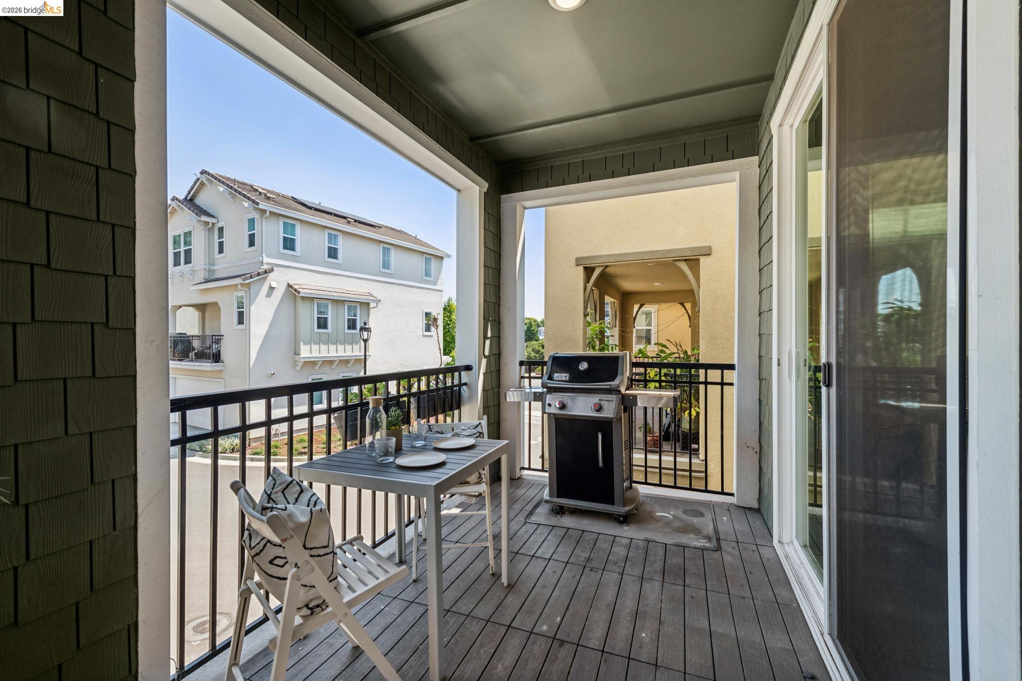 24157 Amaranth Loop Hayward, CA 94541 - Photo 50 of 63 Private balcony featuring wood-finish flooring, a metal railing, and a sliding glass door