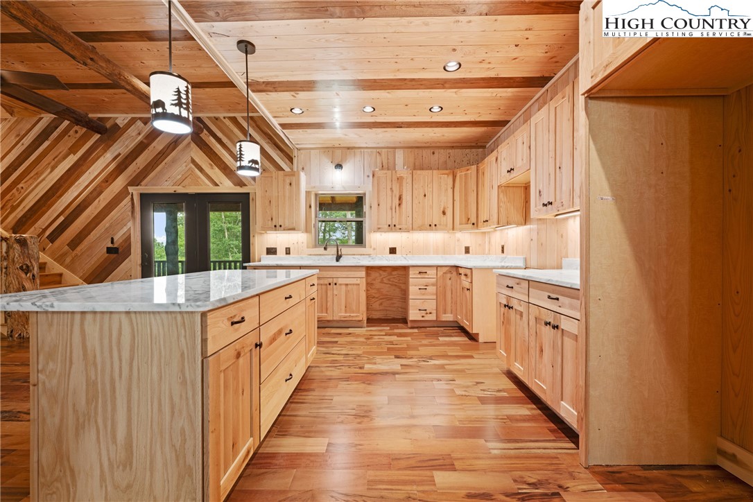 449 Hampton Ridge Road Fleetwood, NC 28626 - Photo 13 of 43 a large kitchen with stainless steel appliances granite countertop a sink and cabinets