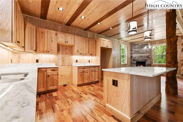 a kitchen with stainless steel appliances granite countertop a sink a stove and a refrigerator