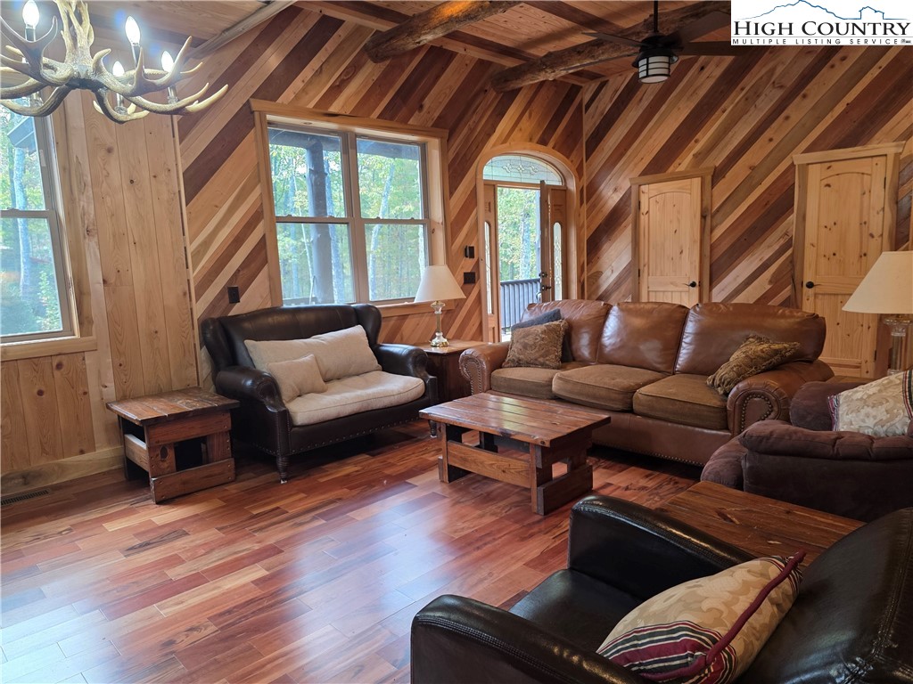 449 Hampton Ridge Road Fleetwood, NC 28626 - Photo 23 of 43 a living room with furniture flat screen tv and a large window