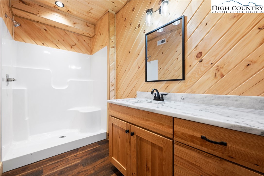 449 Hampton Ridge Road Fleetwood, NC 28626 - Photo 29 of 43 a bathroom with a granite countertop sink and a mirror