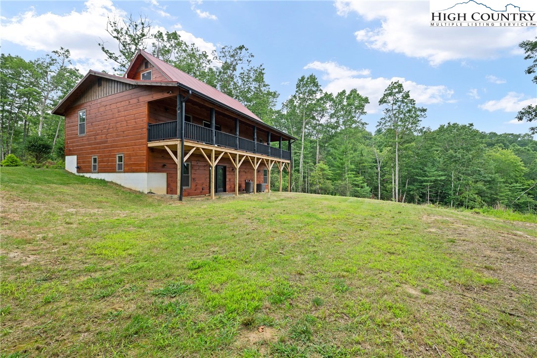 449 Hampton Ridge Road Fleetwood, NC 28626 - Photo 36 of 43 a view of a house with backyard and garden