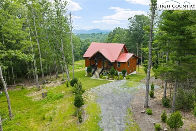 a view of house with backyard and outdoor seating
